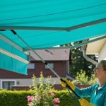 Person-Cleaning-a-Retractable-Awning-1024x768